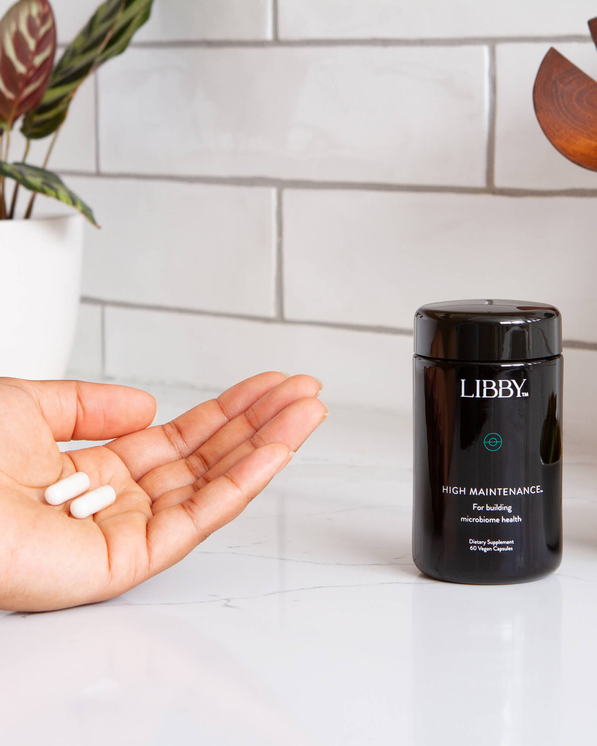 High Maintenance supplement from Libby in palm of hand.