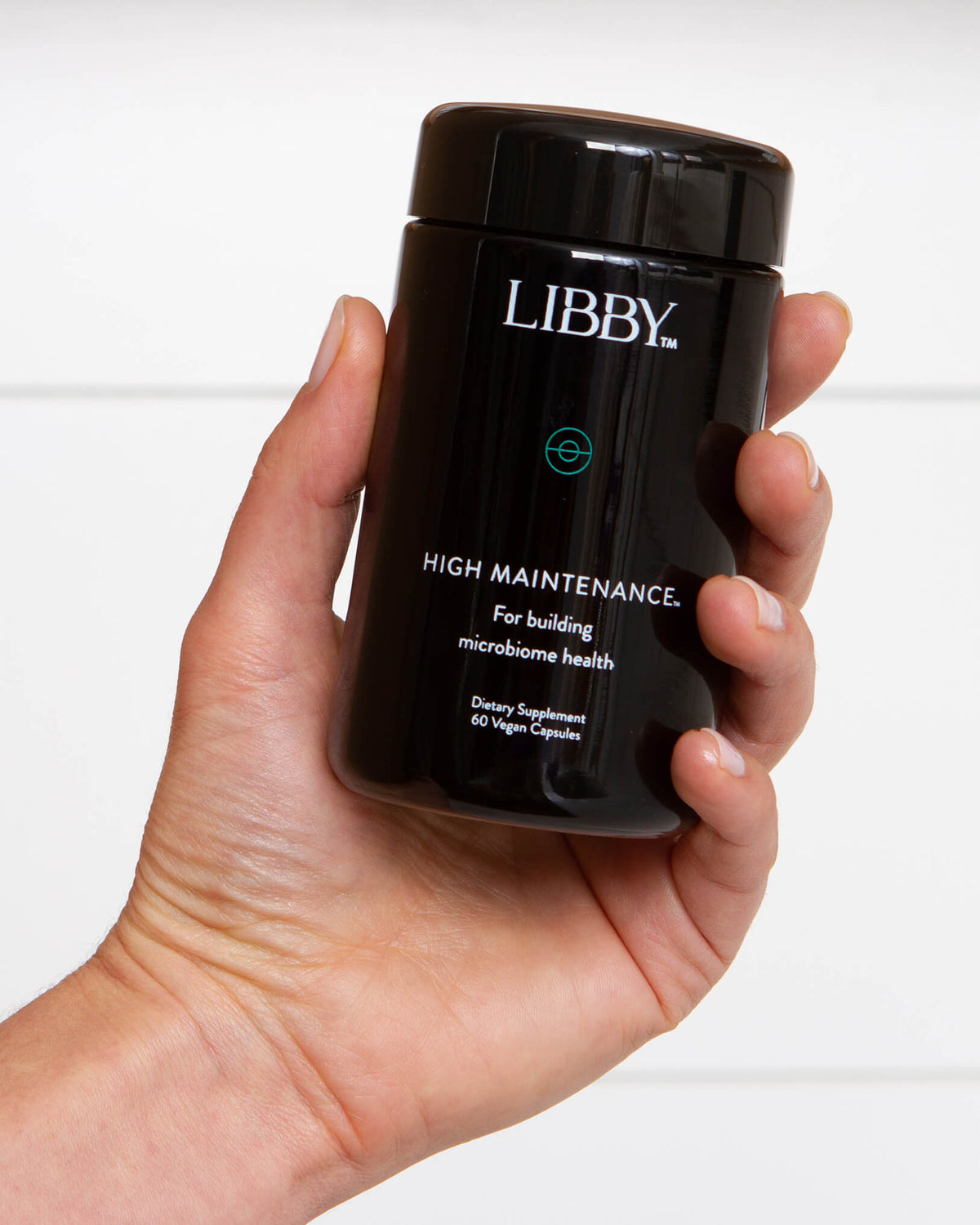 High Maintenance supplement bottle from Libby being held in hand.