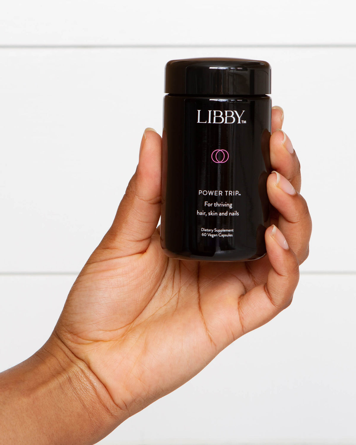 Power Trip supplement from Libby in a black bottle being featured in a hand.