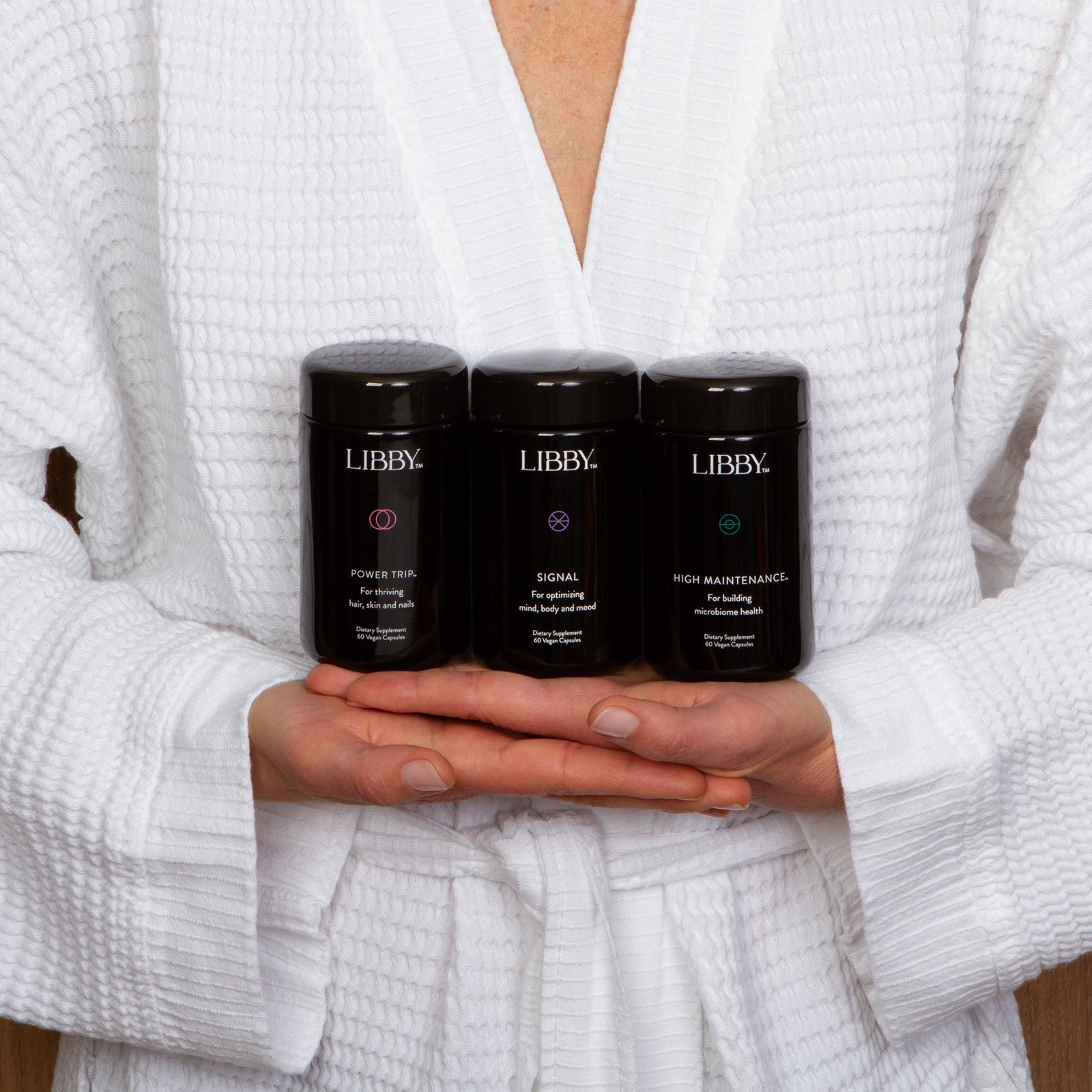 Woman in white robe holding Libby System